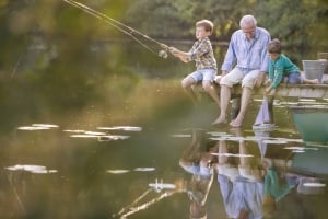 Grandfather fishing with grandkids