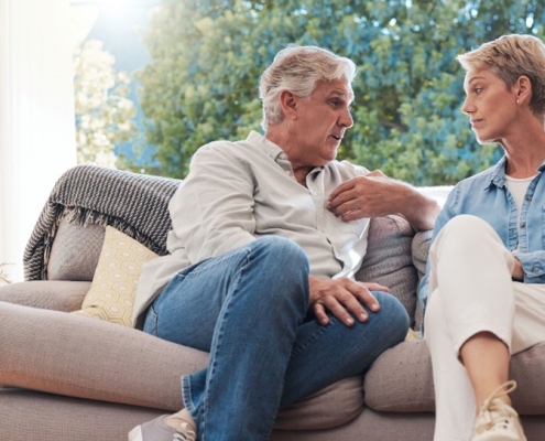 Man and woman on couch having conversation