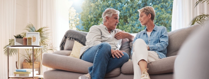 Man and woman on couch having conversation